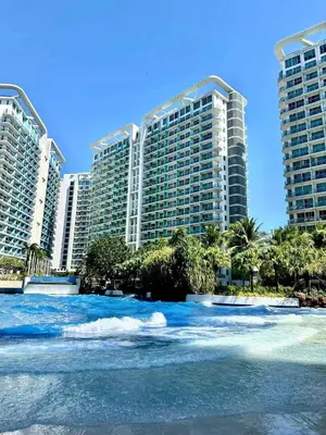 a view of the ocean in front of tall buildings at Quick Stay PH in Manila
