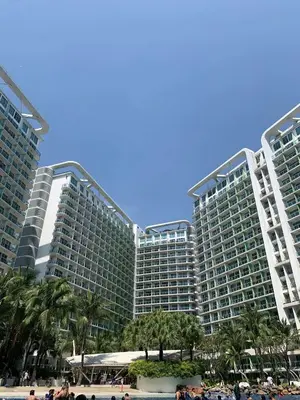 a large building with palm trees in front of it at Quick Stay PH in Manila