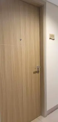 a wooden door in a room with a sign on it at Breeze Residences in Manila