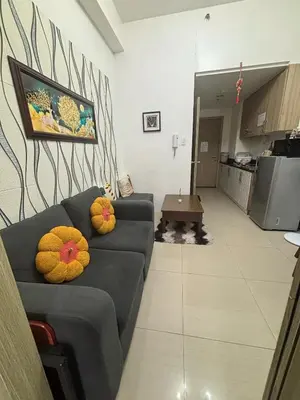 a living room with a couch and a kitchen at AZs Staycation in Manila