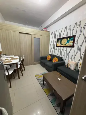 a living room with a couch and a table at AZs Staycation in Manila