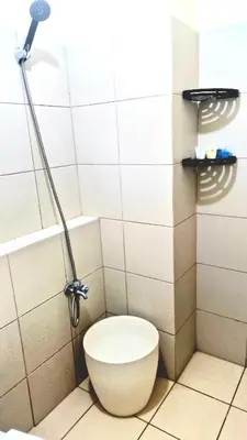 a bathroom with a toilet and a shower at Veronica Grey's Staycation 1BR in Manila