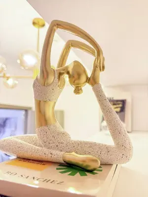 a bronze statue of a woman sitting on a desk at Eastovia Suites city center condo with pool at Fame in Manila