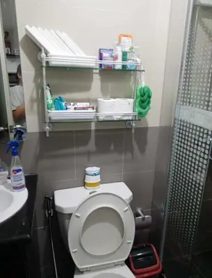 a small bathroom with a toilet and a sink at ADB Ortigas Tower in Manila