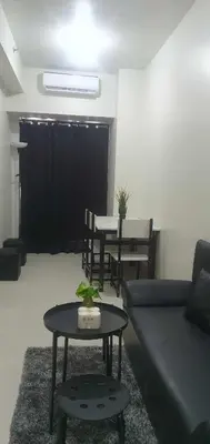 a living room with a couch and a table at StayWisePH at MOA in Manila
