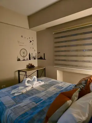 a bedroom with a bed with towels on it at Newport 150 - 1 BR staycation near NAIA 3 in Manila
