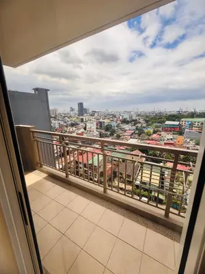 a balcony with a view of a city at Apartment in KAI Garden Residences in Manila