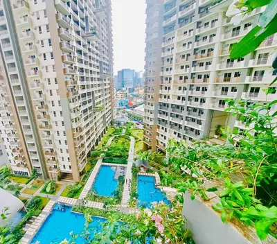 an aerial view of a city with tall buildings at Apartment in KAI Garden Residences in Manila