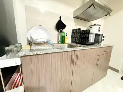 a kitchen with a sink and a counter top at Maiko Happy Studio near US Embassy in Manila