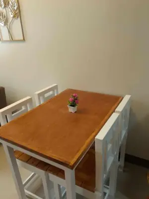 a wooden table with a potted plant on top of it at Charm Residences Staycation by Ashti in Manila
