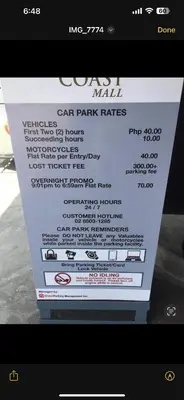 a screenshot of a car park rates sign on a phone at Coast Residences in Manila