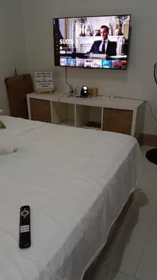a bedroom with a bed with a tv on the wall at Shore 3 Tower 2 near MOA Parking WI-FI Netflix in Manila