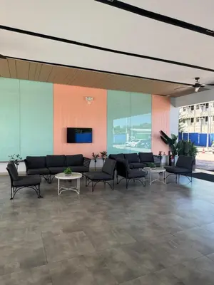 a lobby with a couch and chairs in a building at SMDC Park Residences Unit 202 in Ibaba