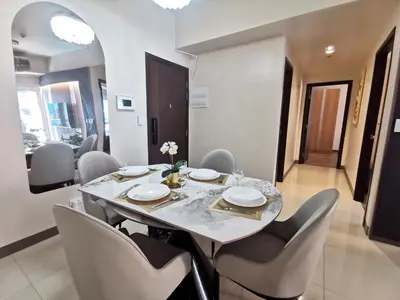 a dining room with a table and chairs at Modern Condo in Prime Location in Manila