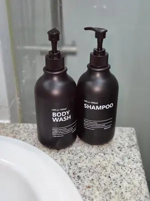 two bottles of soap and shampoo sitting on a bathroom counter at BGC Center Decent 74sqm, 2br, 2baths, 4beds with maid quarter in Manila
