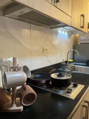 a kitchen with a stove with pots and pans on it at Hiraya Staycation in Manila