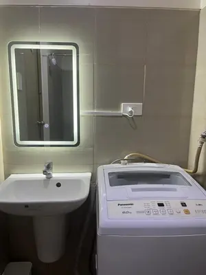 a bathroom with a sink and a mirror at Hiraya Staycation in Manila