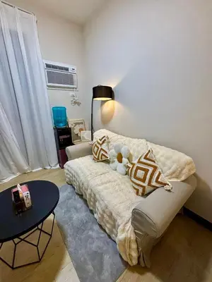 a living room with a couch with a teddy bear on it at Okada Manila Gentry Manor Balcony 1br Unobstructed Scenic View in Manila