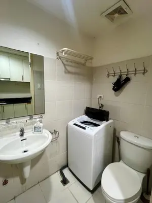a bathroom with a toilet and a sink at Sea Residences Pasay Cozy Studio Steps from SM Mall of Asia and MOA Arena in Manila