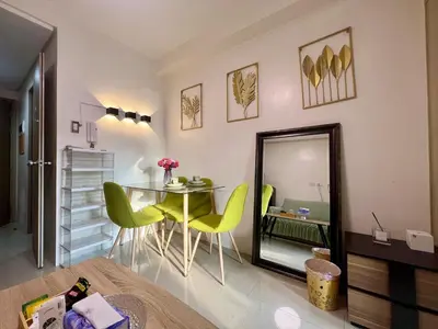 a dining room with a table and chairs and a mirror at Shore Residences Pasay Balcony Studio Unobstructed View Near SM Mall of Asia in Manila