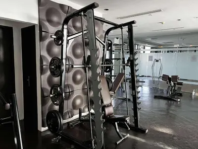 a gym with a bunch of equipment in a room at Gramercy Makati Condotel in Manila