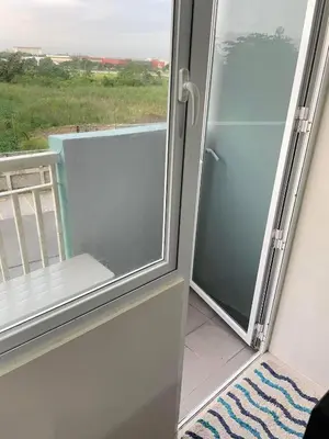 a sliding glass door with a view of a balcony at Cozy condotel Field Residence in Manila