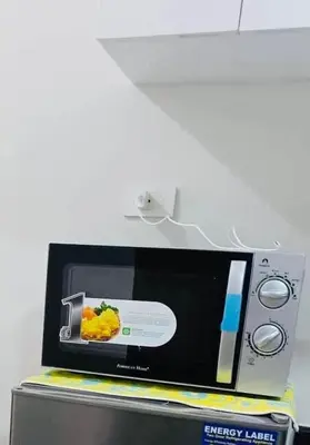 a microwave with a picture of food on it at Cozy condotel Field Residence in Manila