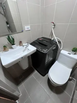 a bathroom with a toilet and a sink at UNISTAY Coast Res R19 w Bal Sunset Vw Worldtrade in Manila