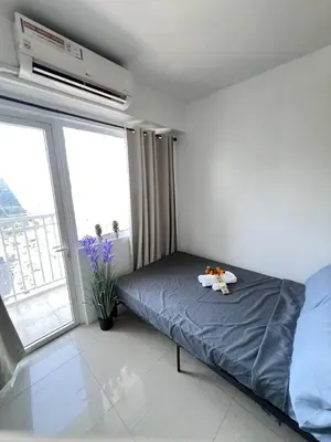a bedroom with a bed with a tray on it at UNISTAY Shore Res w Bal Manila Bay View nr MOA in Manila