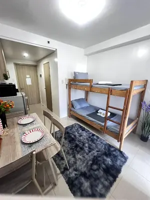 a living room with a table and a bunk bed at UNISTAY Shore Res w Bal Manila Bay View nr MOA in Manila