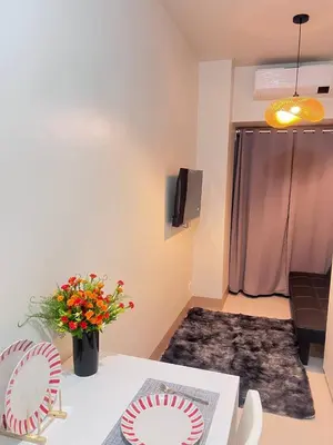 a living room with a table with two paper plates on it at UNISTAY Shore 3 Pool View w Balcony near MOA in Manila