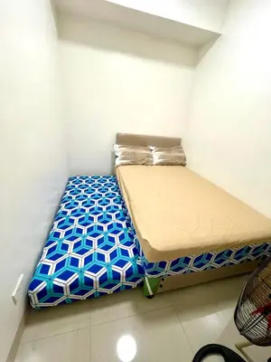 a small bedroom with a bed in a room at Empirestatecation at Leaf Residences in Manila