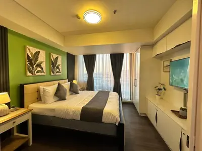 a hotel room with a bed and a television at 1BR Condotel in Azure Urban Resort near NAIA #TRO1 in Manila