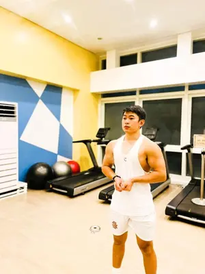 a man is standing in a gym at JFam Suites, C4-10R Studio, Up To 4 Pax in Biñan