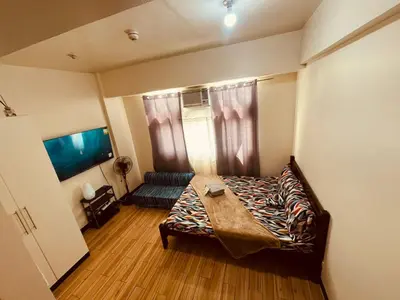 a small room with a bed and a couch at JFam Suites, C4-10R Studio, Up To 4 Pax in Biñan