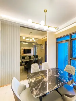 a dining room with a glass table and chairs at Lovely 2br near Airport, Solaire, & Okada - 6pax in Manila