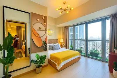 a bedroom with a bed and a large window at Rare 3BR Modern Penthouse in BGC II Sleeps 12pax in Manila