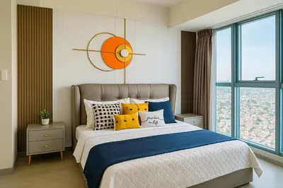 a bedroom with a large bed with yellow pillows at Rare 3BR Modern Penthouse in BGC II Sleeps 12pax in Manila