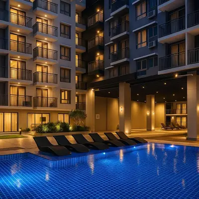 a hotel with a swimming pool in front of a building at Stylish & Cozy 1 bedroom near Mall of Asia in Manila
