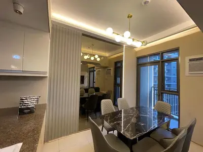 a kitchen and dining room with a table and chairs at Lovely 2 bedroom near Airport & Okada in Manila