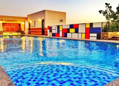 a large swimming pool with colorful tiles on the side of a building at Morgan Suite a6 BGC shortwalk Venice Canal Mall in Manila