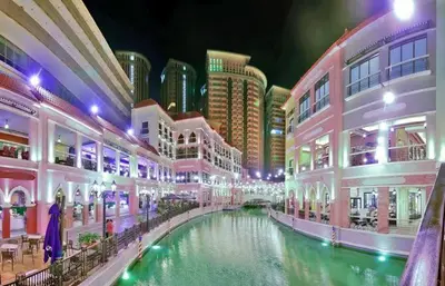 a shopping mall with a river in the middle at Morgan Suite a6 BGC shortwalk Venice Canal Mall in Manila