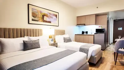 a hotel room with two beds and a kitchen at Savea Bay City Manila in Manila