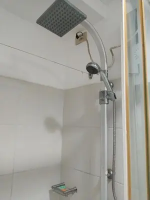 a shower with a shower head in a bathroom at MOA Sea Residences Condotel in Manila