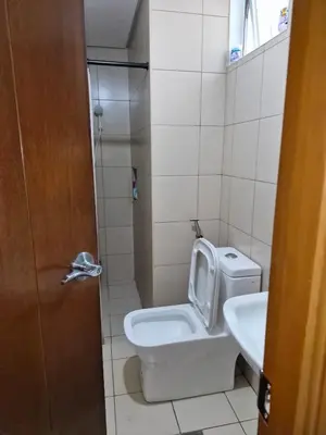 a bathroom with a toilet and a sink at Your 2BR within Pasay in Manila