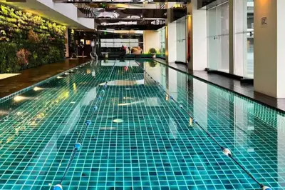 a swimming pool with green tiles on the floor at Green City View Apt in Gramercy Unit 3502 Makati w Netflix in Manila