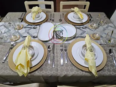a table with white plates and napkins on it at Cozy 2BR UnitN Free Pool Gym with Karaoke Netflix in Manila