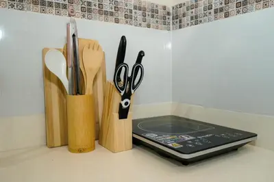 a counter with scissors and a cell phone in a holder at Cozy 2BR UnitN Free Pool Gym with Karaoke Netflix in Manila