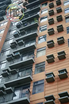 a tall apartment building with balconies and a kite at Cozy 2BR UnitN Free Pool Gym with Karaoke Netflix in Manila