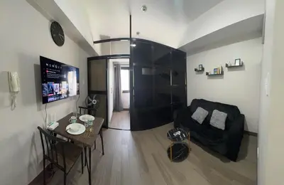 a living room with a couch and a table at Sentinel Residences 1 bedroom partition in Manila